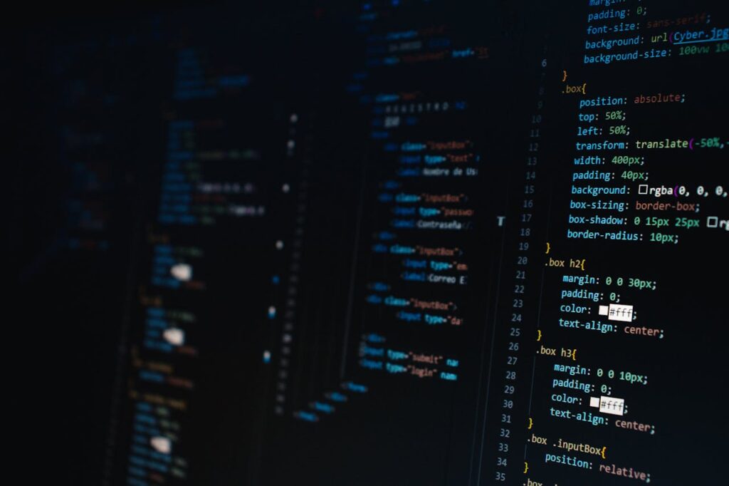 pexels-photo-2653362 Detailed view of HTML and CSS code on a dark screen, representing modern web development.